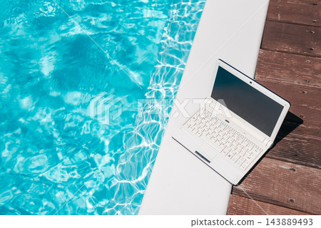 Remote Work by the Swimming Pool with Laptop Mockup Remote Work by the Swimming Pool with Laptop Mockup 143889493
