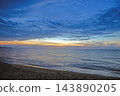 Blue hour above a tranquil beach after sunset at Badesi Sardinia 143890205