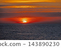 Red sun sinking into the Mediterranean Sea at Badesi Sardinia 143890230