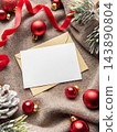Blank christmas card and envelope with red ribbon and ornaments 143890804