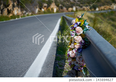 Flowers memorial symbol in a road Flowers memorial symbol in a road 143894627