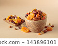 Assorted nuts and dried fruits in wooden bowl on  a beige background. 143896101