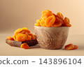 Organic dried apricots in wooden bowl on  a beige background. 143896104
