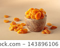 Organic dried apricots in wooden bowl on  a beige background. 143896106