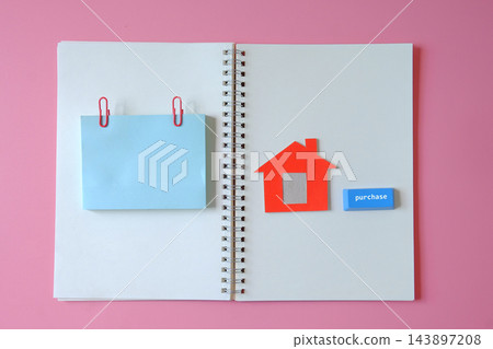 Open booknote with red small house and sticky paper. Open booknote with red small house and sticky paper. 143897208