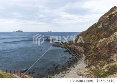 Panoramic view of coastal cliffs, ocean waves, and walking path at Eo Gio in Quy Nhon, Vietnam. Panoramic view of coastal cliffs, ocean waves, and walking path at Eo Gio in Quy Nhon, Vietnam. 143897319