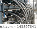 Close-up view of metallic braided flexible hoses and pressure transmitters installed on an industrial plant pipeline. 143897641