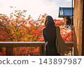 woman view colorful autumn leaf at Kiyomizu-dera hall at sunset, Kyoto 143897987