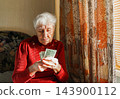 Sad dissatisfied stressed Caucasian old woman count money at home 143900112