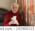Gray hair senior woman with euro cash 143900113