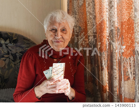 Gray hair senior woman with euro cash Gray hair senior woman with euro cash 143900113