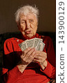 Sad dissatisfied stressed Caucasian old woman count money at home 143900129