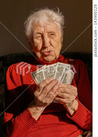 Sad dissatisfied stressed Caucasian old woman count money at home Sad dissatisfied stressed Caucasian old woman count money at home 143900129