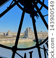 Iconic giant clock inside Musee d Orsay in Paris with Roman numerals and a view of the city through the transparent clock face. High quality photo 143900549
