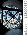 Iconic giant clock inside Musee d Orsay in Paris with Roman numerals and a view of the city through the transparent clock face. High quality photo 143900550