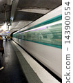 Paris Metro train arriving at a station, captured with intentional motion blur as an artistic photographic technique, creating dynamic light trails and a sense of movement on the platform. High 143900554