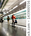 Paris Metro train arriving at a station, captured with intentional motion blur as an artistic photographic technique, creating dynamic light trails and a sense of movement on the platform. High 143900556