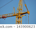 Yellow Tower Crane Top Section Against Blue Sky Background 143900623