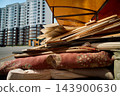 Discarded Household Waste with High Rise Building Background 143900630