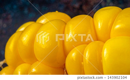 Vibrant yellow balloons clustered together in a close-up view Vibrant yellow balloons clustered together in a close-up view 143902104