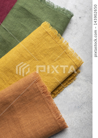 Close Up of Colorful Fringed Linen Napkins Stack 143902650