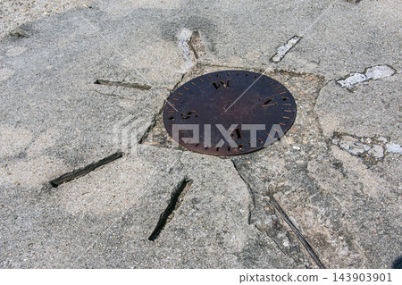 Nitra, Slovakia - May 29, 2024: Compass direction disk on stone pavement Nitra, Slovakia - May 29, 2024: Compass direction disk on stone pavement 143903901