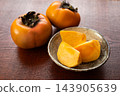 Sliced and whole persimmons 143905639