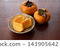 Persimmons placed on a wooden table 143905642