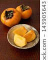 Vertical photo of a sliced persimmon 143905643
