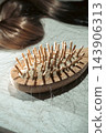 Hair loss; hair tangled in a hairbrush 143906313