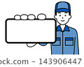 A man in overalls is holding his smartphone screen horizontally to make it appear larger. 143906447