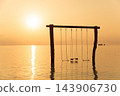 Wooden swings over calm tropical sea at sunrise 143906730