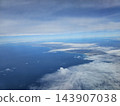 Coastal peninsula and drifting clouds over sea 143907038