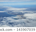 Cloud banks over distant Patagonian coastline 143907039