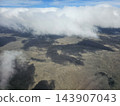 Low clouds casting shadows on arid terrain 143907043