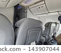 Empty passenger airplane seats and overhead bins 143907044