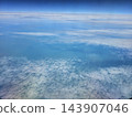 Scattered cotton clouds over hazy blue landscape 143907046