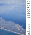 Steep coastal edge and ocean seen from aircraft 143907050