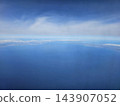 Wide blue sea with distant coastal strip 143907052
