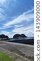 A seaside overlooking a summer blue sky and a calm harbor and island silhouette. 143909000