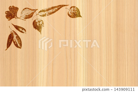 Natural wood material with the silhouette of fallen leaves burned into it. Natural wood material with the silhouette of fallen leaves burned into it. 143909111