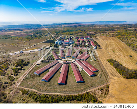 Aerial view of a prison complex with rows of buildings and farmland in a rural region during daytime Aerial view of a prison complex with rows of buildings and farmland in a rural region during daytime 143911400