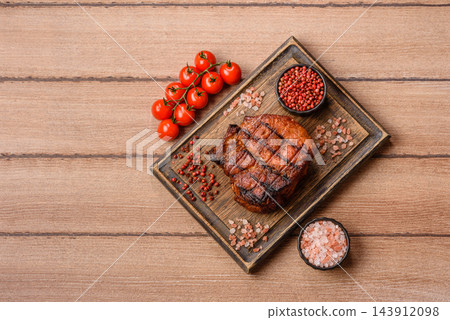 Juicy grilled beef steak seasoned with salt, spices, and herbs. Beef steak 143912098