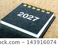 2027 Yearly Desk Calendar Cover Page on Cork Background. 143916074