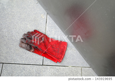 Fireproof gloves on the ground 143919695