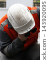 Man working with fireproof uniform and hard hat 143920095