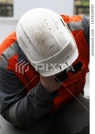 Man working with fireproof uniform and hard hat 143920095
