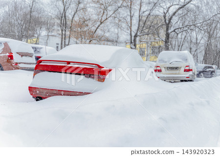 Red Car Buried Under Deep Snow. Heavy Winter Snowfall. Bright car remains buried under snow in parking lot, severe winter weather. Heavy snow covers car, transportation disruption, extreme cold Red Car Buried Under Deep Snow. Heavy Winter Snowfall. Bright car remains buried under snow in parking lot, severe winter weather. Heavy snow covers car, transportation disruption, extreme cold 143920323