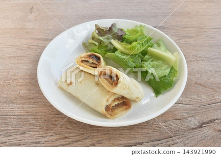 burrito stuffed pork tonkatsu with curry sauce eat couple fresh mixed vegetable salad on plate burrito stuffed pork tonkatsu with curry sauce eat couple fresh mixed vegetable salad on plate 143921990