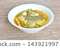 boiled red mango fish with pickled bamboo shoot in spicy and sour yellow curry soup Thai southern food on bowl 143921997